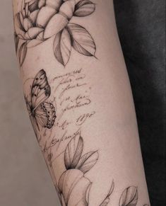 a woman's arm with flowers and butterflies on it