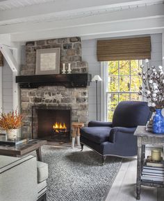 a living room filled with furniture and a fire place next to a brick fireplace in a home