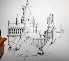 someone is drawing a castle on paper