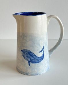 a blue and white whale mug on a table