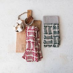 two tea towels and some cinnamon sticks on a cutting board