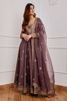 Dark purple anarkali with gold dori, aari and sequin embroidery. Comes with churidar and dupatta.
Component: 3
Pattern: Embroidery
Type Of Work: Sequin, Dori and Aari
Neckline: U neck
Sleeve Type: Full
Fabric: Chanderi, Organza and Cotton Silk; Lining: Shantoon
Color: Purple
Other Details: 
Dupatta with embroidered border
Occasion: Wedding - Aza Fashions Grand Anarkali Dress, Purple Pakistani Suit, Jigar Mali, Purple Anarkali, Chanderi Anarkali, Silk Anarkali Suits, Desi Outfits, Lehenga Designs Simple, Anarkali Dress Pattern