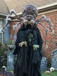 a man dressed up as a spider in front of a house