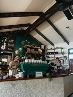 a coffee shop with people working behind the counter