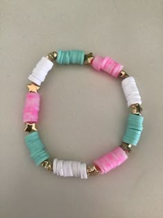 a bracelet with pink, white and blue beads on it's end is shown