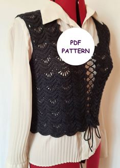 a mannequin wearing a black and white top with crochet on it