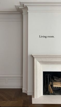 an empty living room with a fireplace and white walls that have writing on the wall