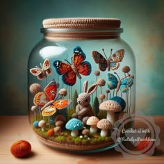 a glass jar filled with lots of different types of mushrooms and butterflies on top of a wooden table