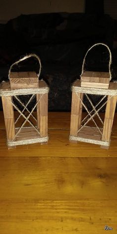 two small wooden lanterns sitting on top of a wooden floor