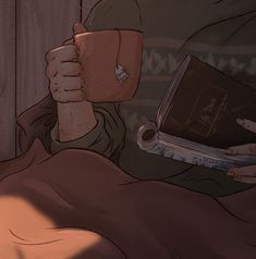 a man laying in bed with a book and cup next to him on his hand