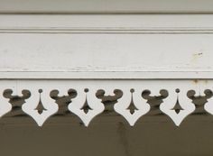 a close up view of an ornate design on a building's front door frame