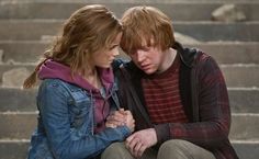 a young man and woman are sitting on the steps looking at each other's eyes