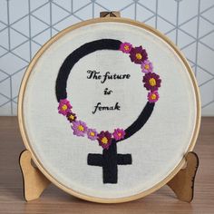 a cross and flower wreath with the words, the future is female