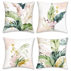 four pillows with tropical leaves and flowers on them, one is white the other is pink