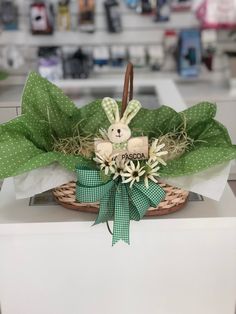 a basket filled with flowers and a teddy bear sitting on top of a white counter