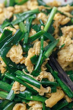 green beans and chicken are mixed together in a dish with chopsticks on the side