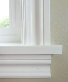 an open window with white trim on a wall