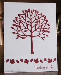 a white card with a red tree on it and the words thinking of you written below