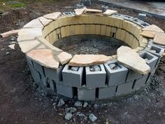 an outdoor fire pit made out of cinder blocks