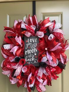 a valentine's day wreath with love you to the moon and back written on it