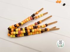 some candy sticks are arranged in the shape of a caterpillar on a white table