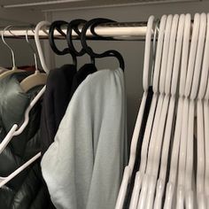 some clothes hanging on a rack in a closet