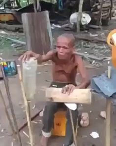 an old man sitting on top of a wooden bench next to another man with glasses