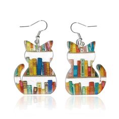 two pairs of cat shaped earrings with bookshelves in the shape of cats on them