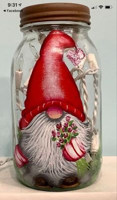 there is a glass jar with a gnome in it