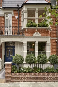 a brick house with two balconies on the second floor