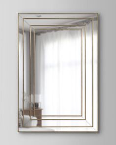 a gold framed mirror hanging on the wall