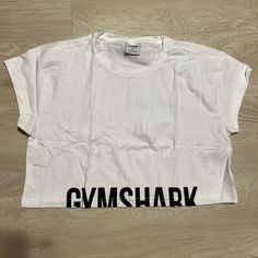 Brand New, Never Worn. White Gym Shark Crop Top Gym Shark Crop Top, Dream Dresser, Macys Outfits, Gymshark Crop Top, Gymshark Shirt, Cropped Workout Top, White Gym, Cropped Tee Shirt, Gym Shark