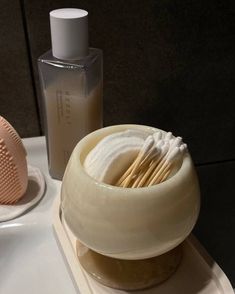 a bathroom sink with soap and toothbrushes on the counter next to each other