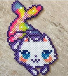 the pixel art is made out of plastic beads and has a unicorn on it's head