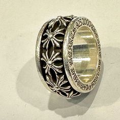 two silver rings sitting next to each other on top of a white surface with writing