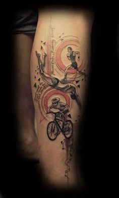 a man's leg with a tattoo on it and a bicycle in the middle