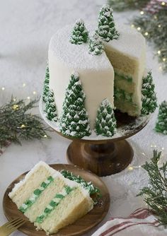 two pieces of cake sitting on top of plates next to each other with green frosting