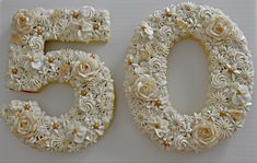 the number fifty five made out of flowers and icing on a white tablecloth