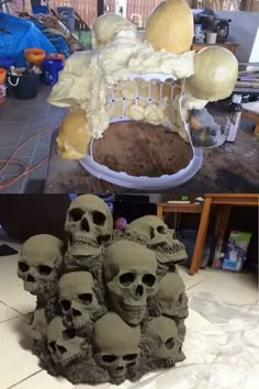 there are many skulls that have been made out of clay and then put together to make a sculpture