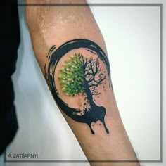 a man's arm with a tree in the center and water dripping from it