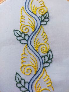 an embroidered design with yellow and blue thread