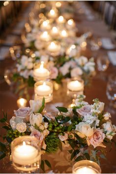 a long table with candles and flowers on it