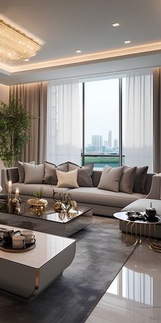 a living room with couches and tables in front of large windows overlooking the city