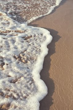 the water is foamy and brown on the beach