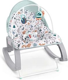 a baby's rocking chair with an animal print on the back and seat cover