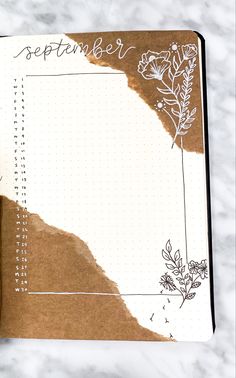 an open notebook with flowers and writing on it