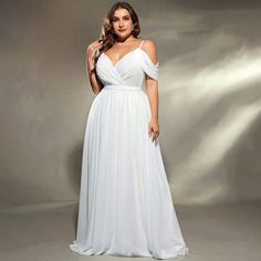 a woman in a white dress posing for the camera with her hands on her hips