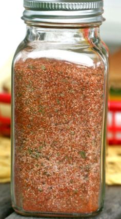 a jar filled with lots of red stuff on top of a table