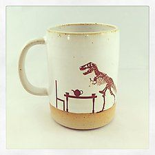 a coffee mug with a dinosaur on it