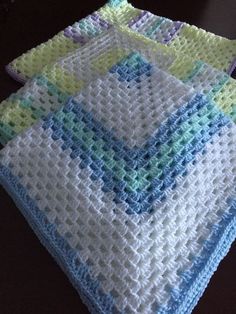 two crocheted dishcloths sitting on top of a table